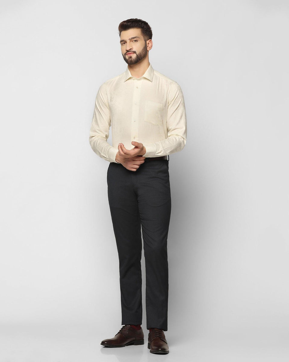 cream colour shirt and black pant