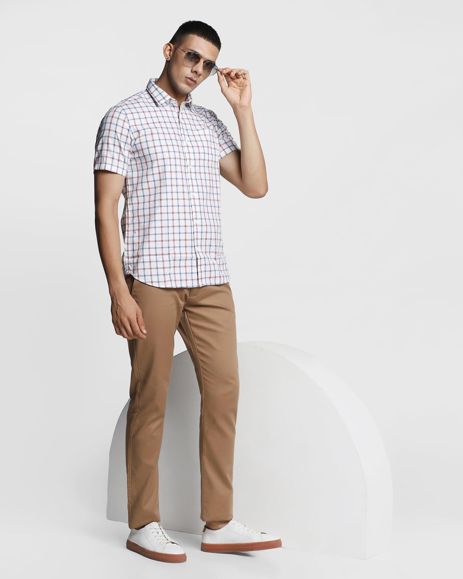 a man in a white shirt and brown pants generative ai 32090959 Stock Photo  at Vecteezy